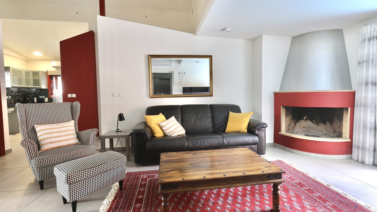 This is the spacious living room with a fireplace at The Bordeaux Door