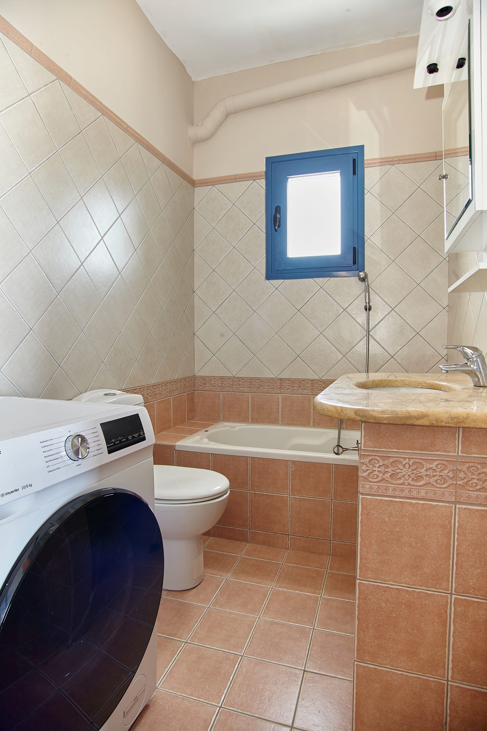 Second bathroom Bathroom with washing machine and bathtub